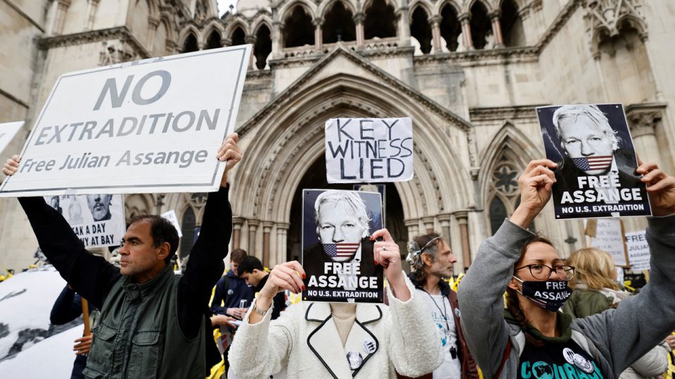Protesters hold placards during a demonstration outside the Royal Courts of Justice in London on October 28, 2021, the second day of an appeal hearing by the US government against the UK's refusal to extradite WikiLeaks founder Julian Assange. - The United States urged two senior British judges to clear the extradition of WikiLeaks founder Julian Assange and reject a lower court's ruling that he is a suicide risk. (Photo by Tolga Akmen / AFP)